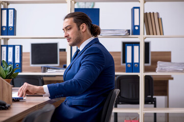 Young male employee working in the office