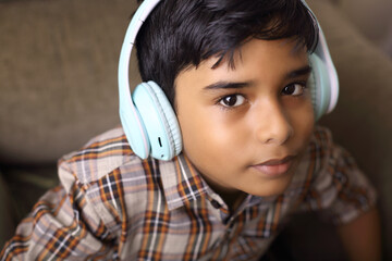 Indian young boy listen the speach with headphone	
