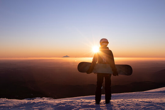 View of Mount Taranaki from Turoa Skifield, snowboarder in background, winter season, New Zealand
