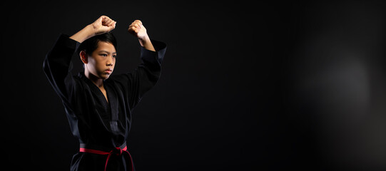 Fototapeta na wymiar TaeKwonDo Karate teenager athlete kick punch black background isolated