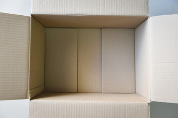 Open cardboard box on floor background High angle view of an empty cardboard box or Parcel box