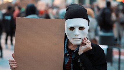 Protest and demonstrations. rebellious woman with face mask striking . High quality photo