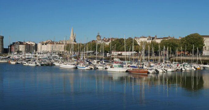 La Rochelle,Charente Maritime department, Region Nouvelle Aquitaine, France. View of the old harbour. On the right side is the Grosse Horloge tower, on the left side are the harbour towers.