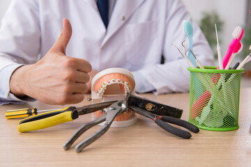 Young male doctor stomatologist working in the clinic