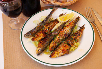 Beer snack - fried sardines with lemon and parsley