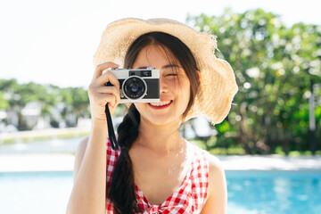 Fototapeta na wymiar Portrait of asian woman wear hat taking photo with camera.