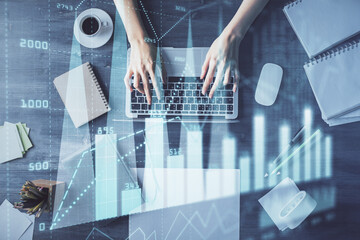 Multi exposure of woman hands working on computer and forex chart hologram drawing. Top View....
