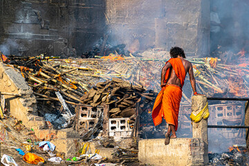 an indian monk(aghori) satanding at the holy Manikarnika ghat at Varanasi,Cremation ceremony in Manikarnika