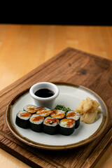 Sushi rolls as a lunch in european cafe, wooden table, side view