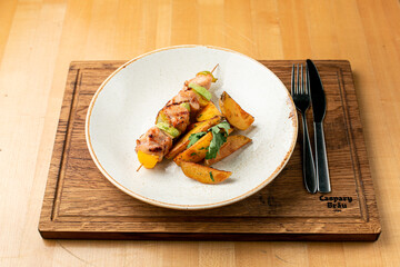Chicken breast shashlik with squash slices, served with baked potato as a side dish