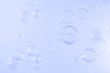 Transparent clear soap bubbles float on blue background. Abstract, Natual fresh summer a blue texture.