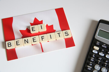 Winnipeg, Manitoba / Canada - October 24, 2020: Employment Insurance Conceptual Title. Top view of Connected Letters Game with a Canadian Flag Card and a Calculator in the Background.