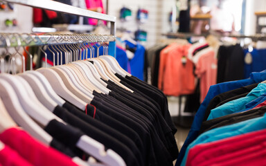 Sportswear on hangers in sports goods shop