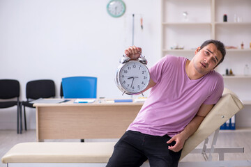 Young male patient waiting for doctor in time management concept