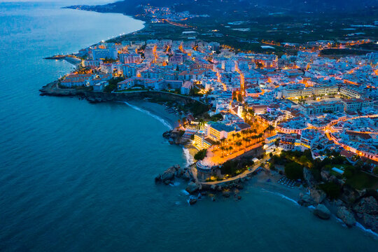 Aerial view of Nerja city with coastline in province of Malaga at night, Andalusia, southern Spain