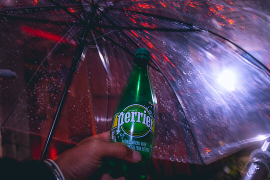 holding Perrier bottle at rainy night at Nov 2018 in Japan