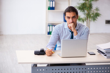 Young male employee working in the office