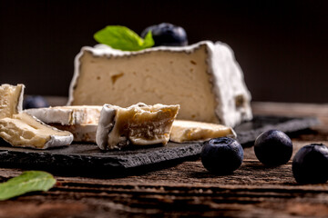 Craft cheese from cows and goats milk. Soft french cheese with ash, goat cheeses, home made cheese farmer
