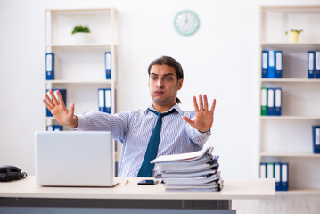 Young male employee working in the office