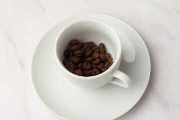 white cup with coffee beans.