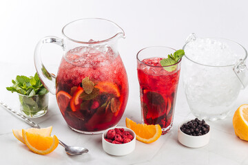Glass and jug of fresh red berry lemonade