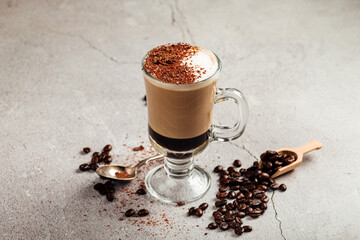 Mocaccino coffee in a glass mug with beans