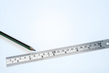 Pencil and ruler on white background