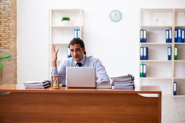 Young male employee in time management concept