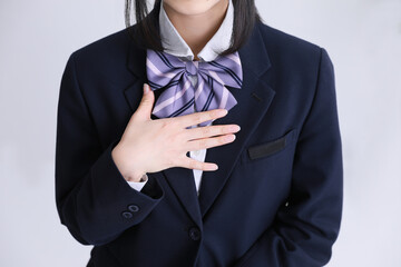 制服の女子高生が胸に手を当てている　girl student uniform