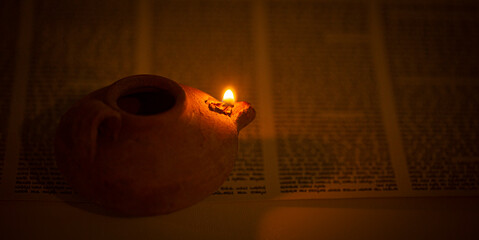Ancient Lamp Illuminating the Hebrew Text of the Torah