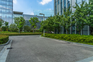 clean asphalt road through office block area, suzhou, china