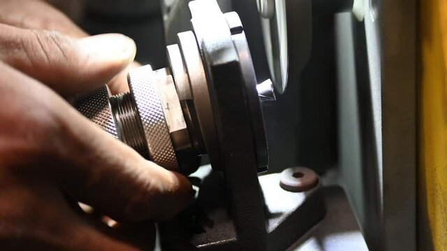 The manual operation of end mill regrinding machine. The sharpener solid end mill tool process by skill operator.