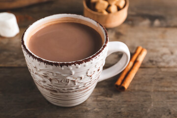 Cup of hot cacao drink on table