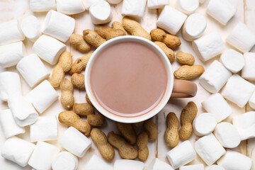 Cup of hot cacao drink with marshmallows and peanuts on table