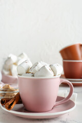 Fototapeta na wymiar Cup of hot cacao drink with marshmallows on table