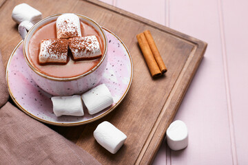 Cup of hot cacao drink with marshmallows on table