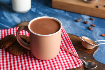 Cup of hot cacao drink on table