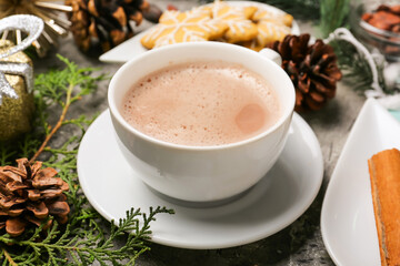 Cup of hot cacao drink with Christmas decorations on table