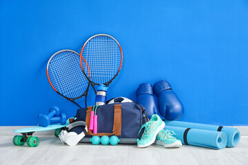 Set of sport equipment on floor near color wall