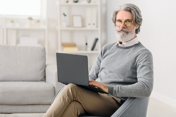Portrait of senior male psychologist in office
