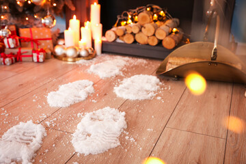 Footprints of Santa on floor in room decorated for Christmas