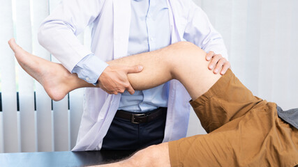 physiotherapist doctor rehabilitation consulting physiotherapy giving exercising knee treatment with patient in physio clinic or hospital.