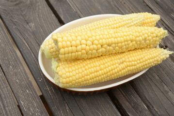 kidneys of raw corn lie on a dark wooden background
