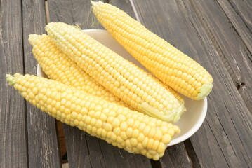 kidneys of raw corn lie on a dark wooden background