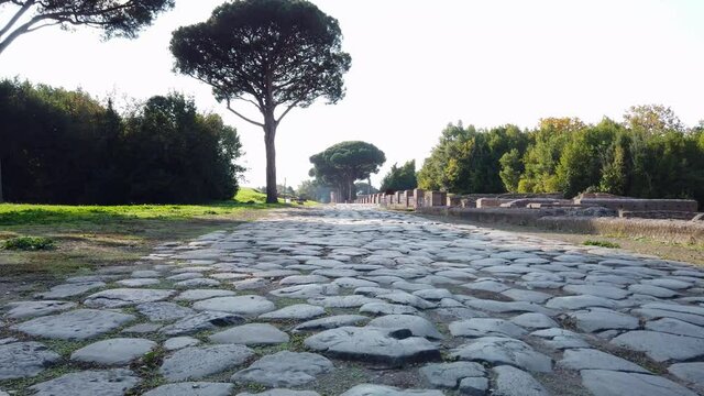 Roman road stone-paved at the entrance of Ostia Antica, a world famous archeological site.