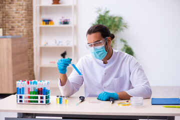 Young male chemist working in the lab