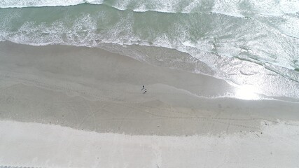 person walking on the beach