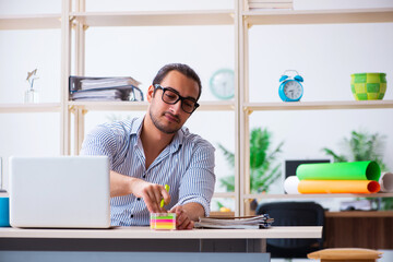 Young male employee working in the office