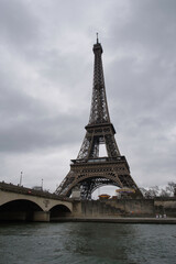 Fototapeta na wymiar The Eiffel Tower seen from the Seine on a cloudy morning. Paris, France.