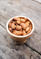 Almonds in a wooden bowl on the table